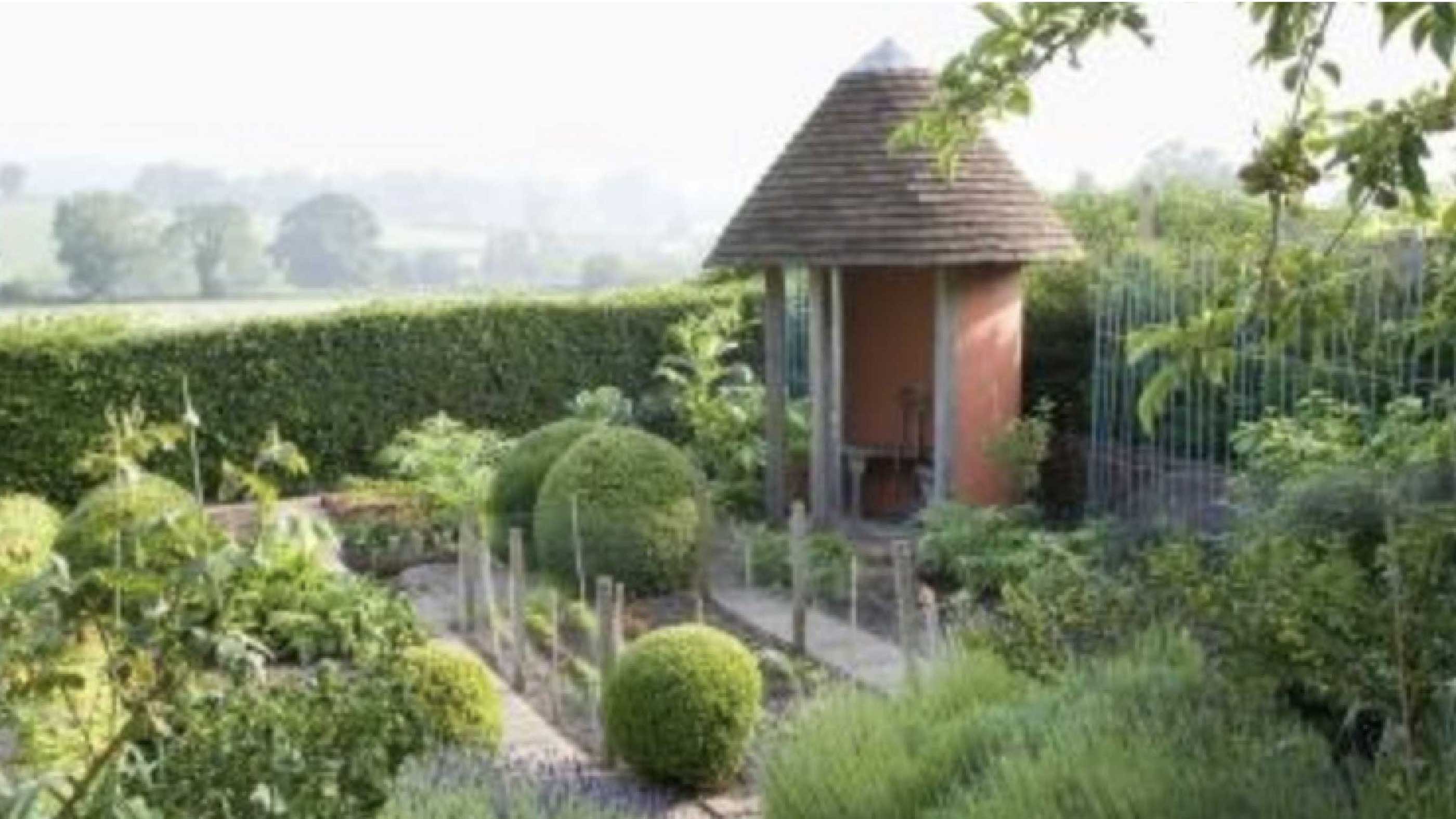 A beautiful English formal garden — topiary and borders in summer